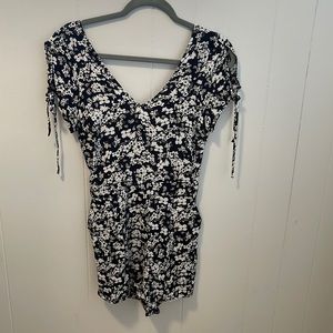 Express floral romper with pockets and back keyhole.